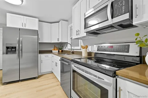a kitchen with stainless steel appliances granite countertop a stove and a refrigerator