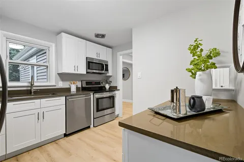 a kitchen with a sink stove and microwave