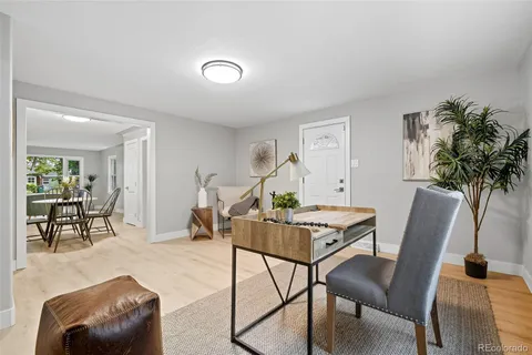 a living room with furniture and a potted plant