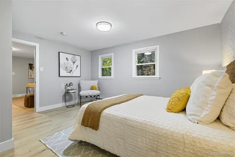 a bedroom with a bed and painting on the wall