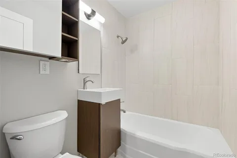 a bathroom with a toilet a sink and bathtub