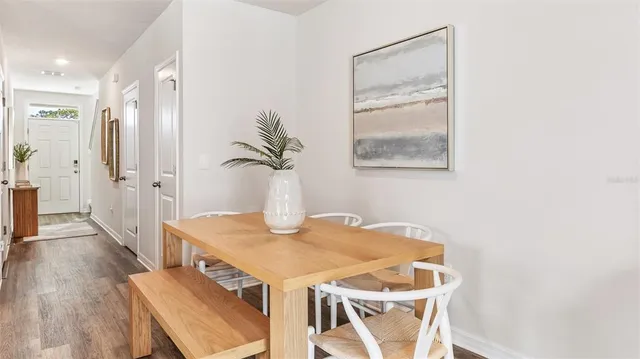 a view of a dining room with furniture and wooden floor
