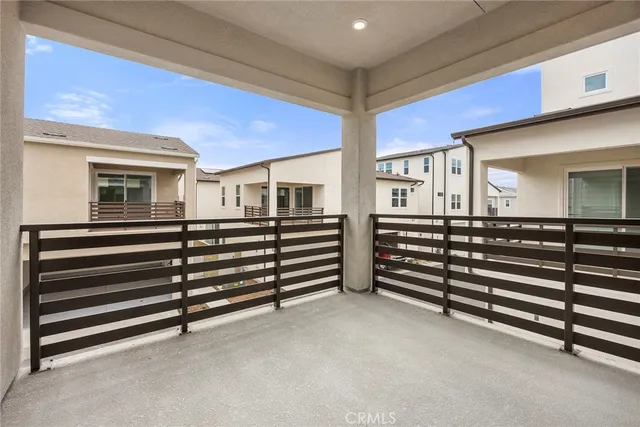 a view of an empty room with stairs and a ceiling fan