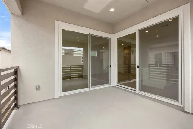 an empty room with sliding door and shower
