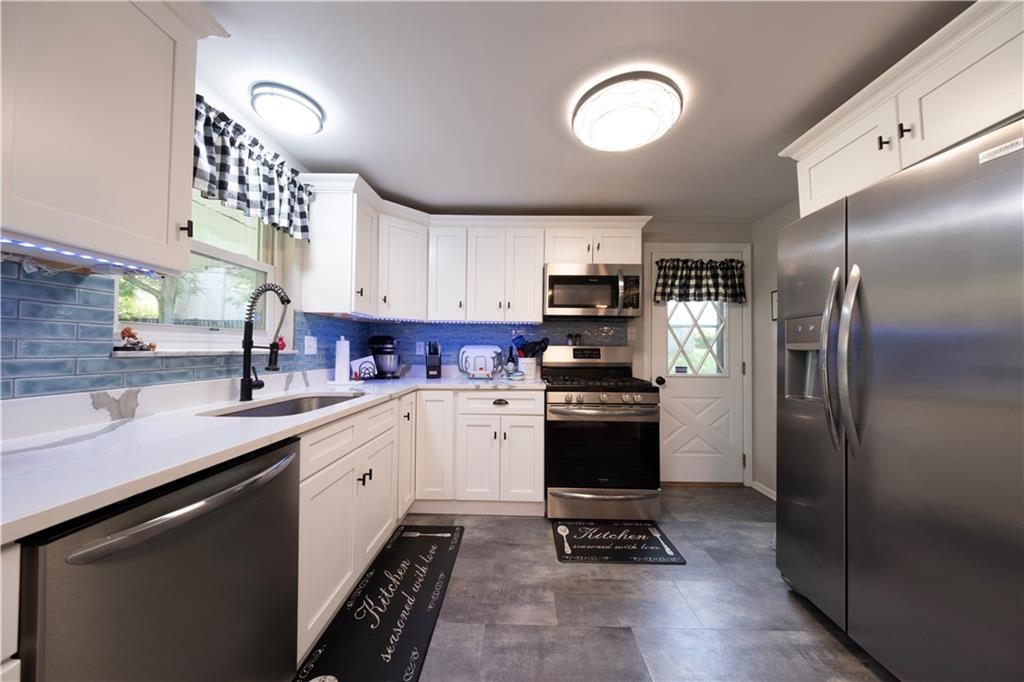 325 Clements Road Pittsburgh, PA 15239 - Photo 8 of 28 Quartz countertops, under cabinet lighting, and newer stainless appliances