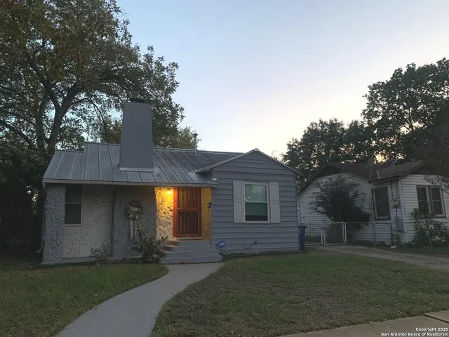 a front view of a house with a garden and yard