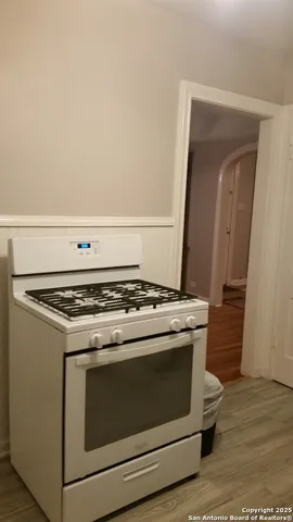 a stove top oven sitting inside of a kitchen
