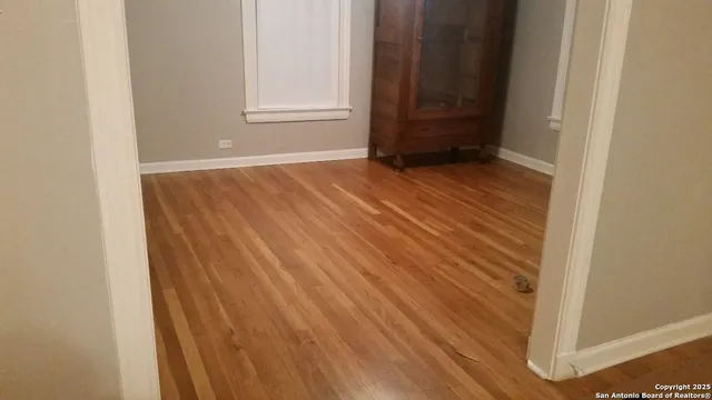 a view of an empty room with wooden door