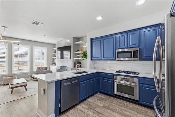 a kitchen with a sink stove and microwave