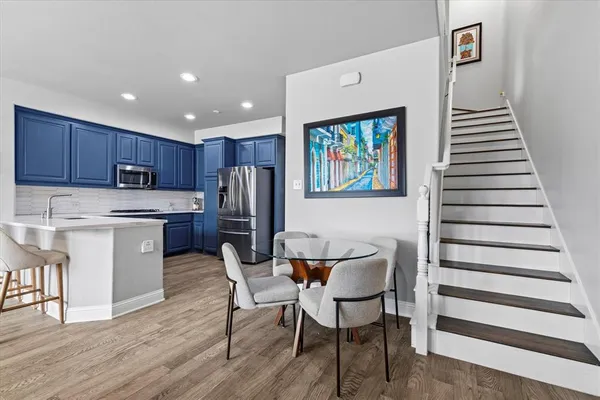 a kitchen with stainless steel appliances granite countertop a refrigerator and a stove top oven