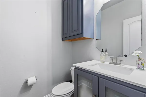 a bathroom with a sink a toilet and mirror