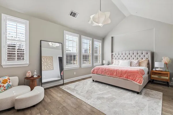 a spacious bedroom with a bed and a couch