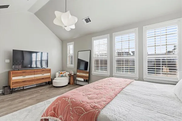 a bedroom with a bed and a large window
