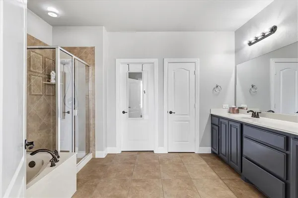 a bathroom with a double vanity sink mirror and shower