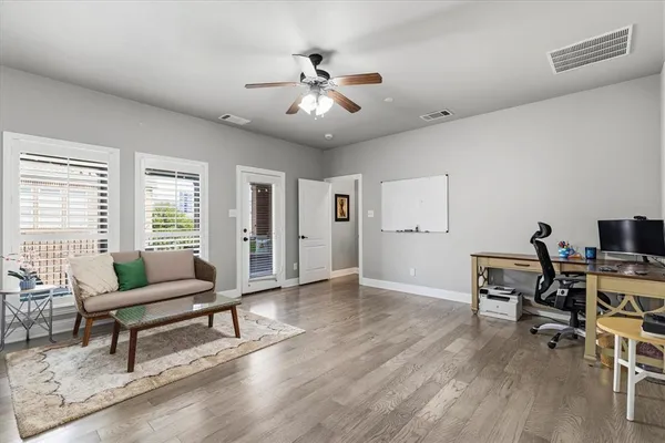 a living room with furniture and a wooden floor