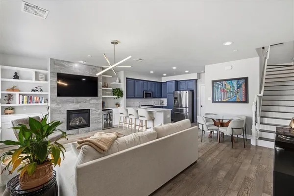 a living room with furniture a fireplace and a flat screen tv