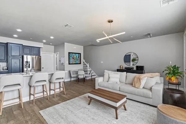 a living room with furniture and kitchen view