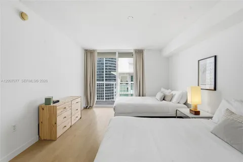 a bedroom with furniture and a large window