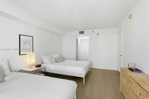 a bedroom with two beds and painted walls