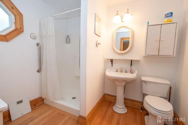 a bathroom with a toilet a sink and a mirror