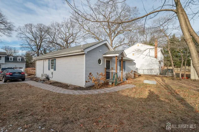 a view of a house with a yard covered in snow