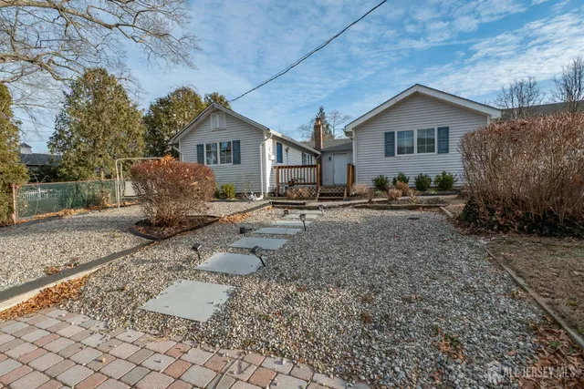 a backyard of a house with garden and patio