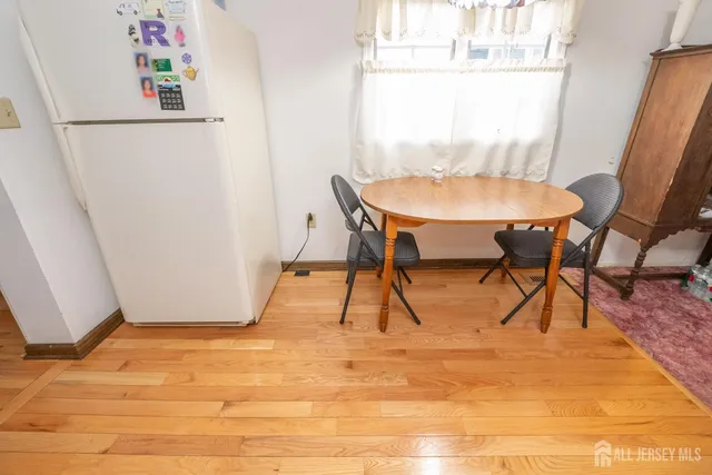 a dining room with furniture and a window