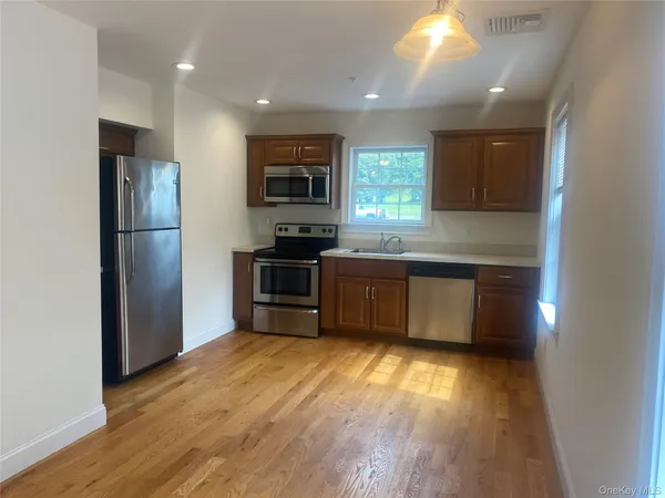 a kitchen with stainless steel appliances a refrigerator and a stove top oven