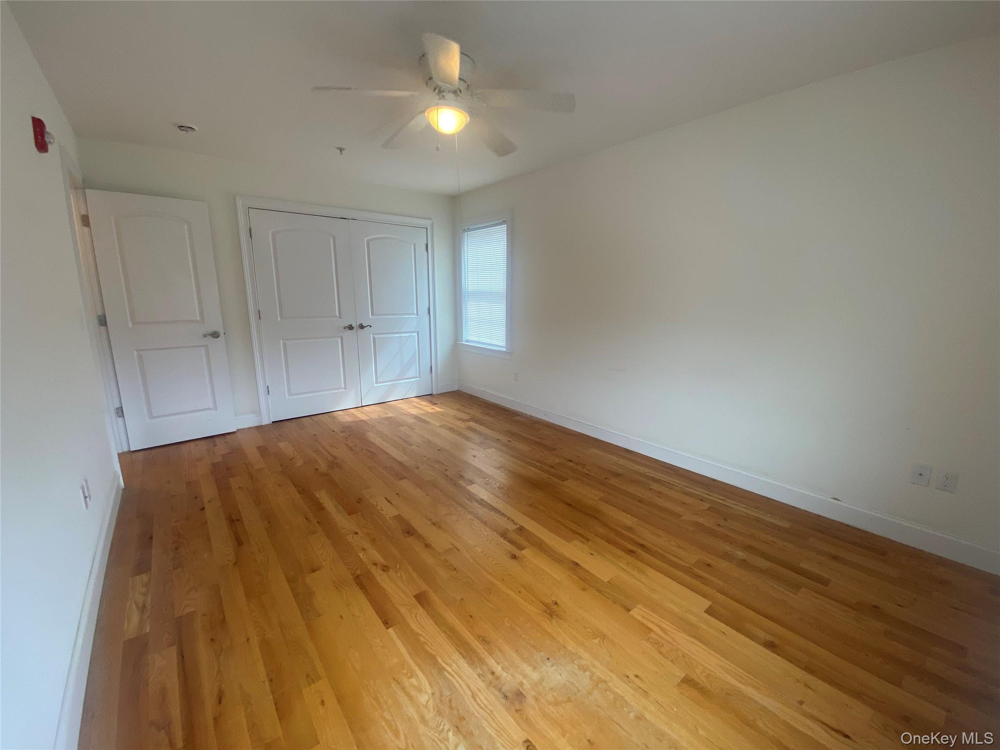 27 North Main Street Florida, NY 10921 - Photo 11 of 20 Unfurnished bedroom with light wood-style flooring, ceiling fan, and a closet