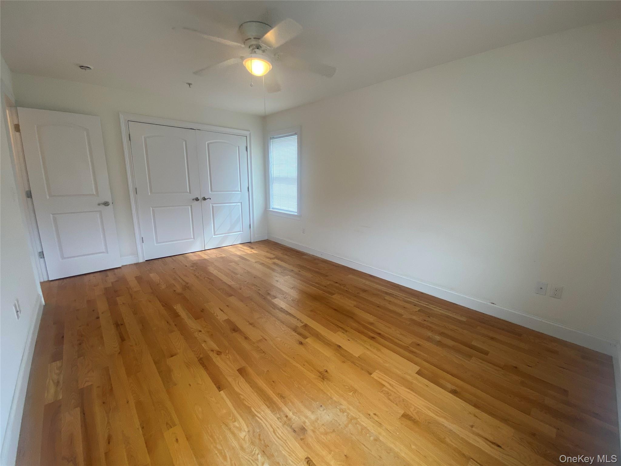 27 North Main Street Florida, NY 10921 - Photo 12 of 20 Unfurnished bedroom with light wood-style floors, ceiling fan, and a closet