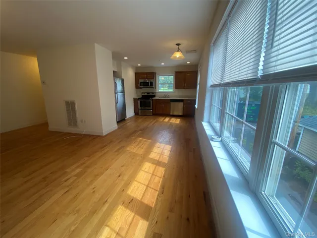 a view of a kitchen with wooden floor and a sink