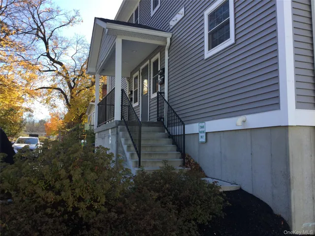 a view of a pathway of a house with backyard and trees