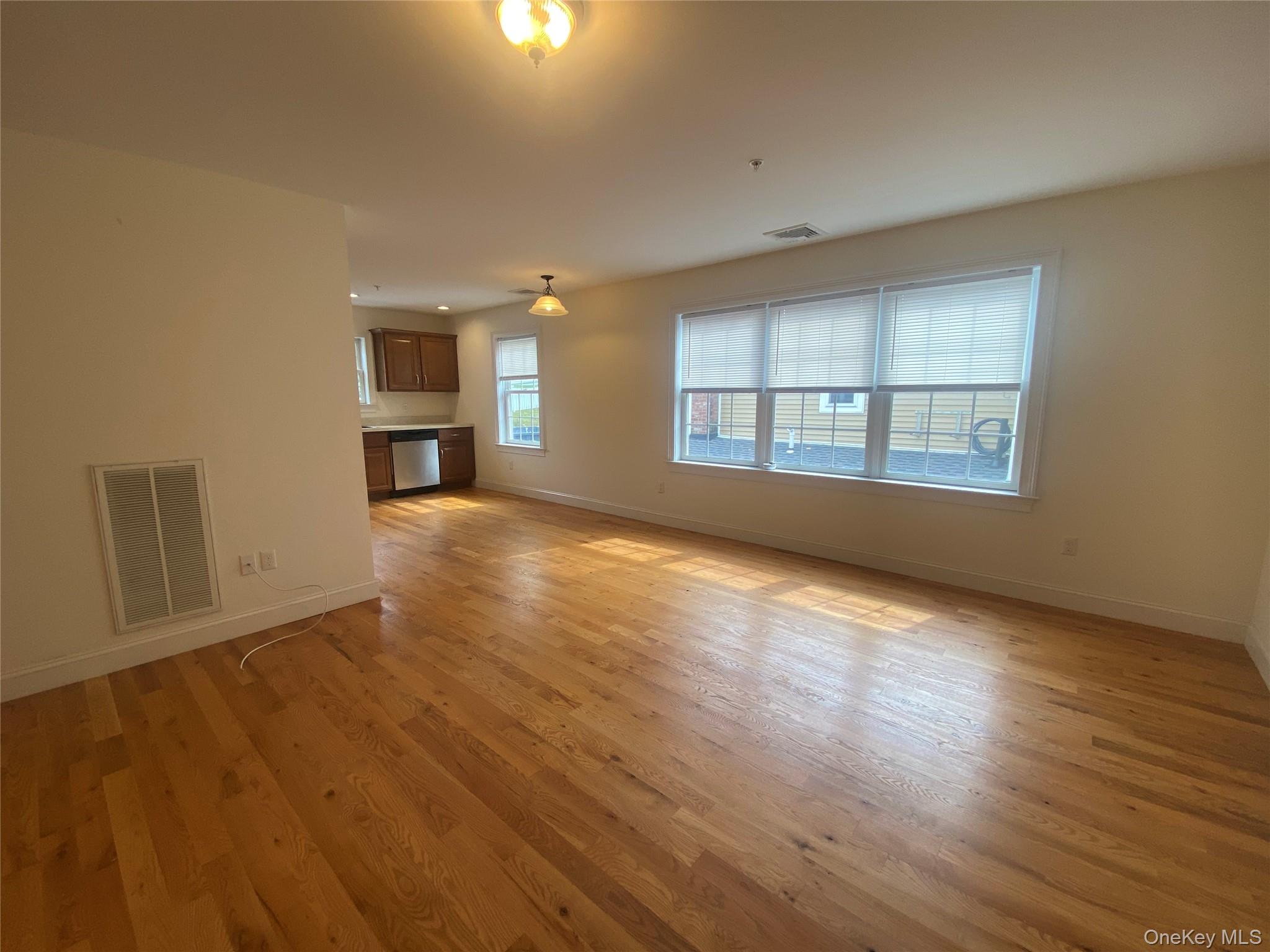 27 North Main Street Florida, NY 10921 - Photo 4 of 20 Unfurnished living room featuring baseboards and light wood-type flooring
