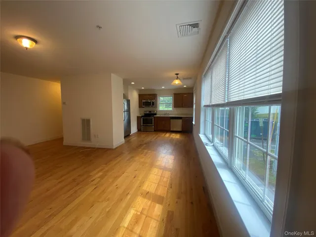 a view of a room with wooden floor