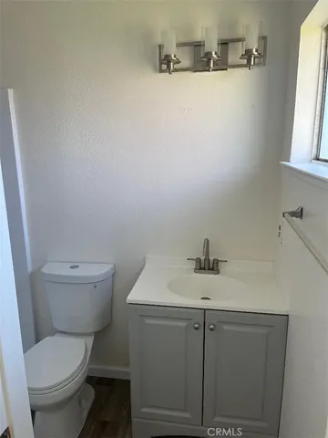 a bathroom with a toilet a sink and a mirror