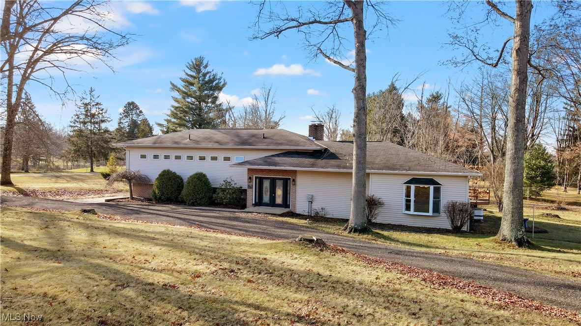 Ranch-style home featuring a front lawn