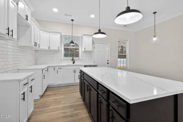 a kitchen with a stove a sink and a refrigerator