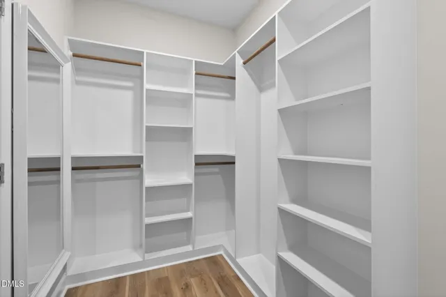 a view of walk in closet with empty racks