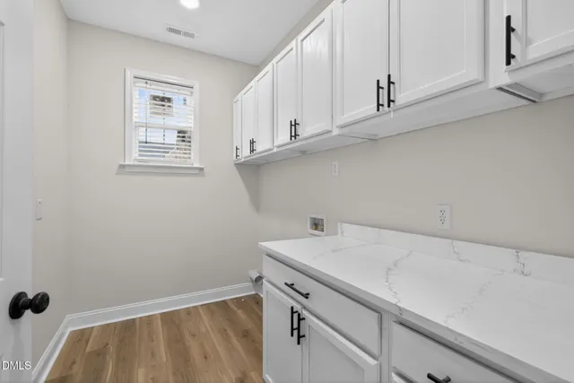 a view of a kitchen with white cabinets