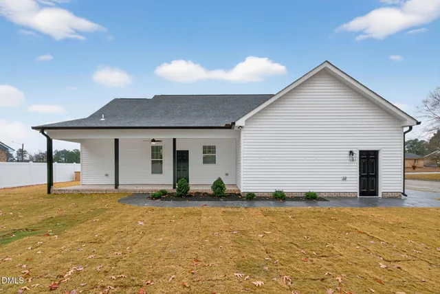 a view of a house with yard and sitting area