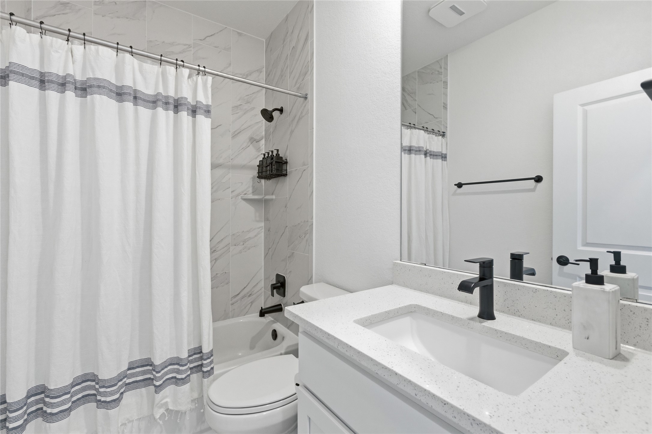 836 Villa Rialto View Leander, TX 78641 - Photo 29 of 33 Refined primary bathroom features a shower and tub combo alongside a sophisticated vanity with ample counter space.