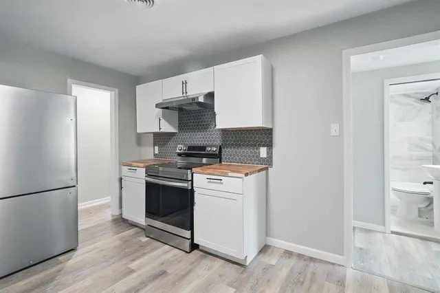 a kitchen with stainless steel appliances a refrigerator stove and sink