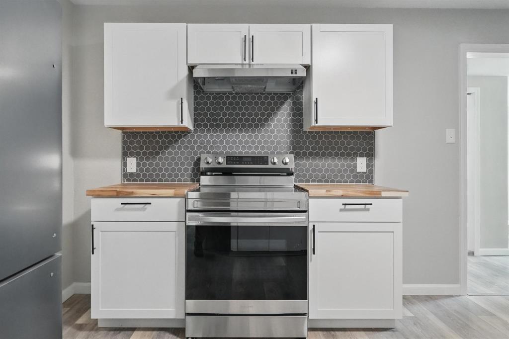 2781 Beech Street, Unit A & B Abilene, TX 79601 - Photo 14 of 35 a kitchen with a stove and white cabinets