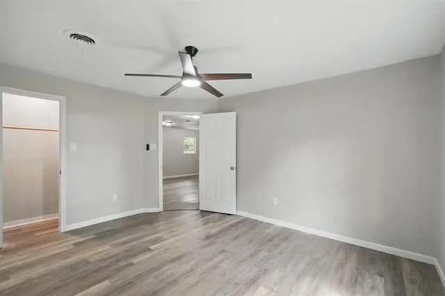 a view of an empty room and wooden floor