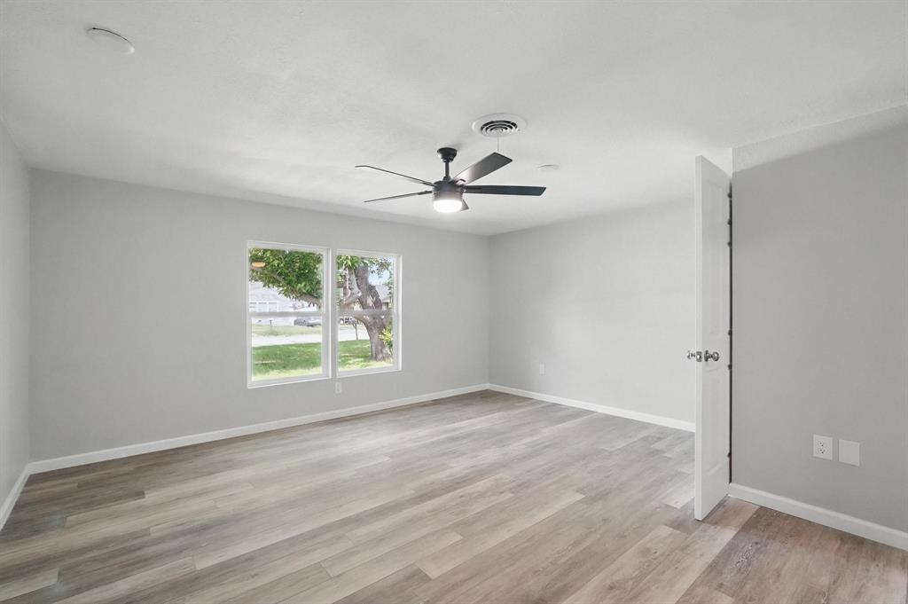 2781 Beech Street, Unit A & B Abilene, TX 79601 - Photo 22 of 35 an empty room with wooden floor and windows