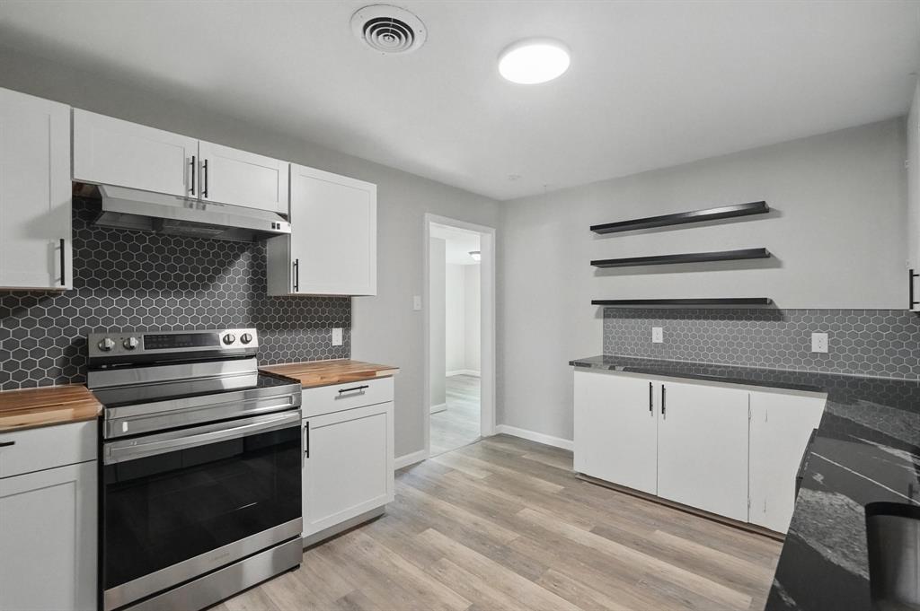 2781 Beech Street, Unit A & B Abilene, TX 79601 - Photo 10 of 35 a kitchen with granite countertop a stove and a sink