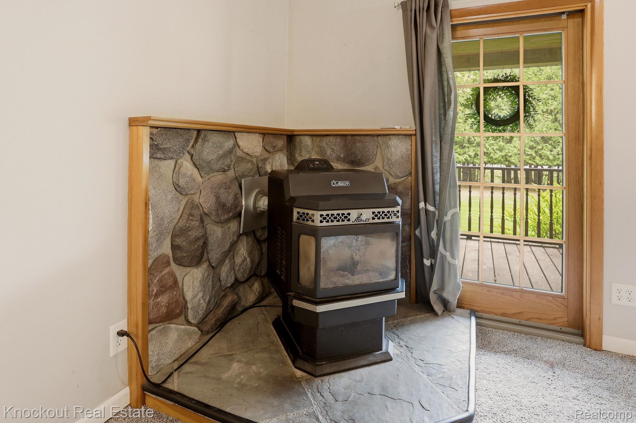 1608 South Pinnebog Road Bad Axe, MI 48413 - Photo 13 of 54 Detailed view of a wood stove and carpet