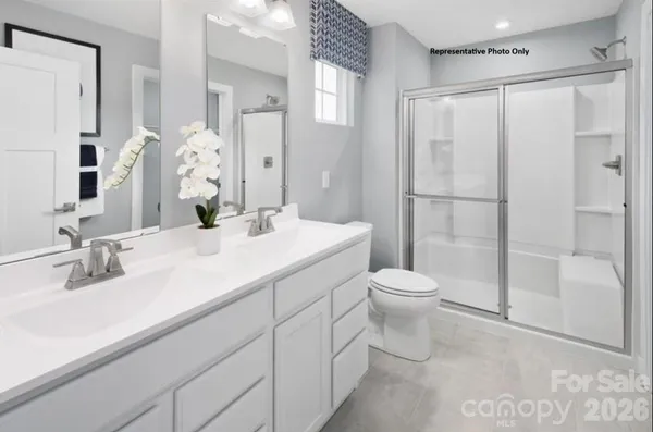 a bathroom with a toilet sink and shower