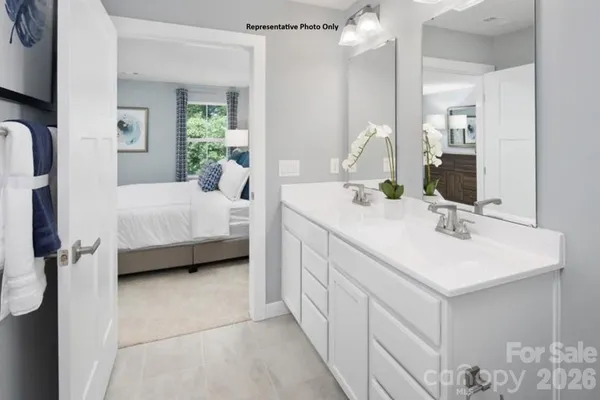 a en suite bathroom with a double vanity sink mirror and