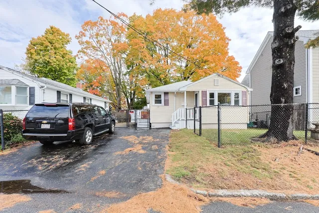 a view of a house with a yard and sitting area